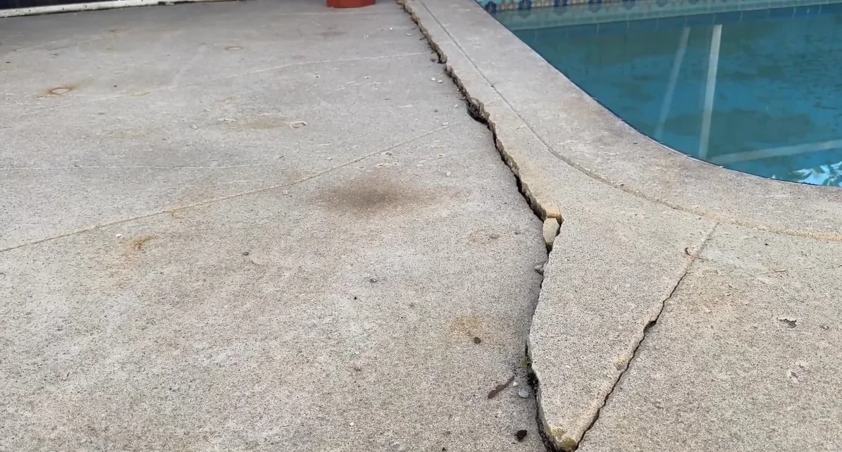 Before: cracked and settled pool deck concrete