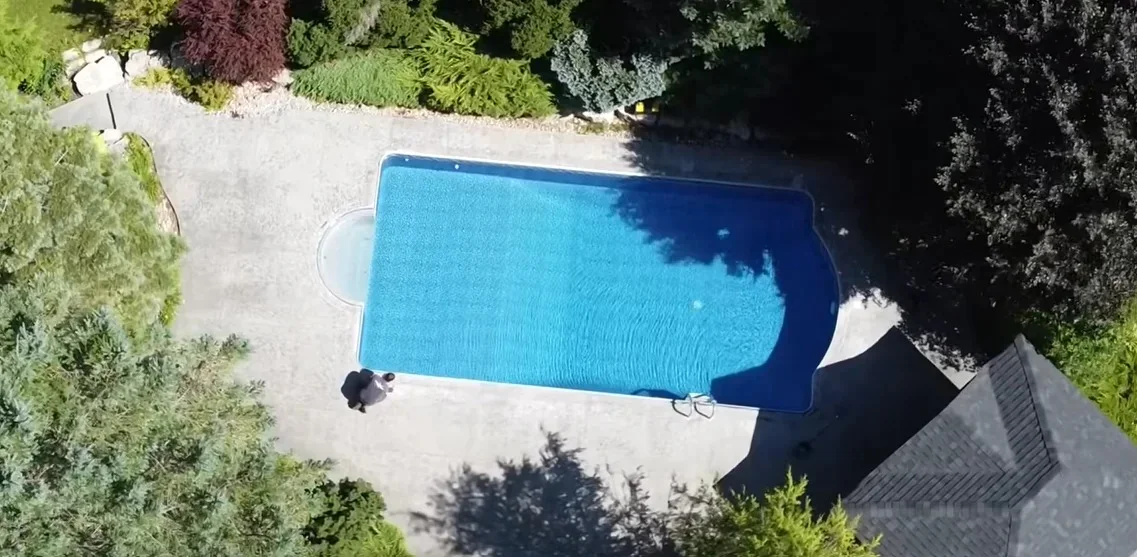 Before: worn pool deck concrete, aerial view
