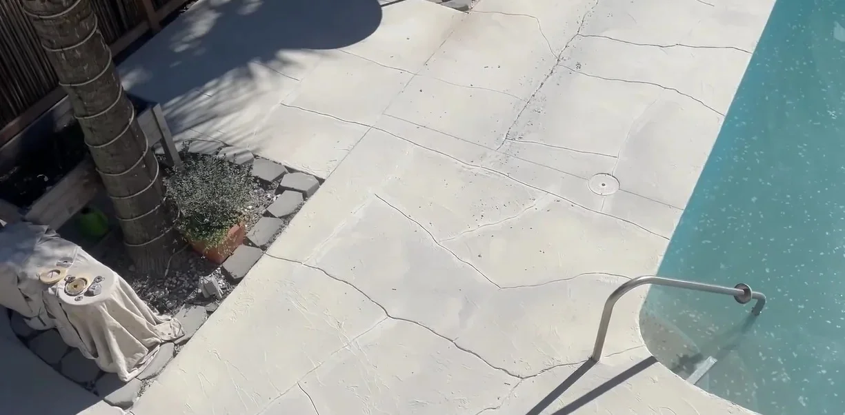 Freshly resurfaced walkway surface near pool edge